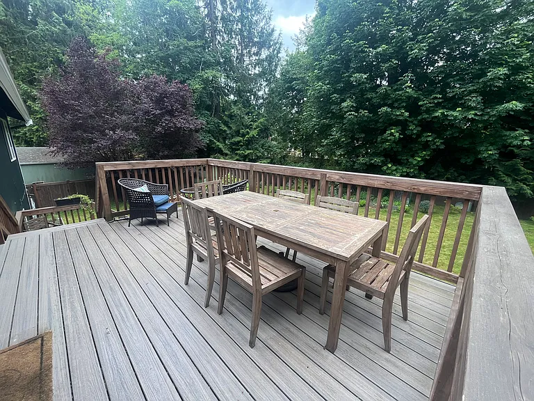 upper deck (off dining room) with stairs leading down to patio/yard. Yard is against protected wetlands, which provide a natural screen to nearby houses
