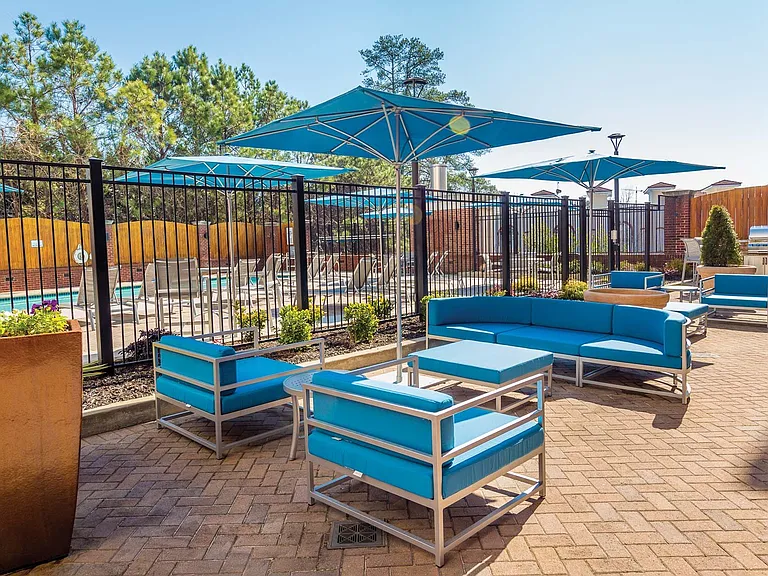 Host a BBQ on the outdoor, poolside patio with stainless steel grill