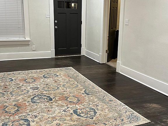 A look back at the front door from the dining room. Open door is to the office/3rd bedroom.