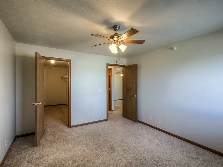 Bedroom with a walk-in closet at Huntington Apartments.
