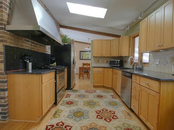Beautifully updated kitchen w/ overhead skylights and Maple Cabinetry.