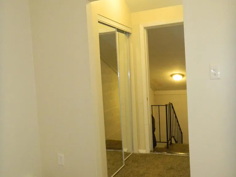 Upstairs Entrance with Mirrored Coat Closet on Left