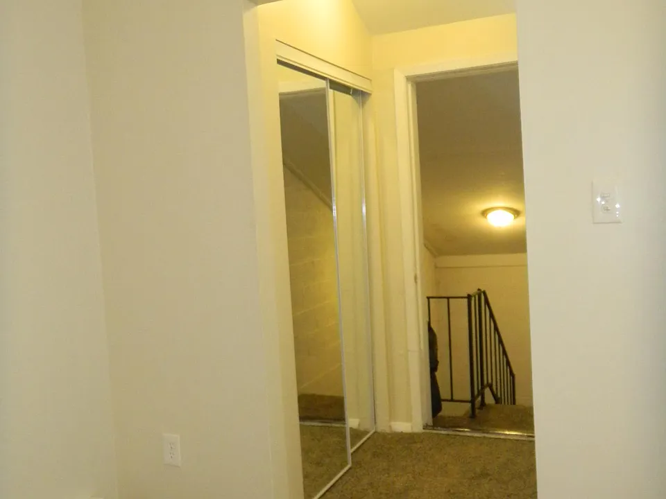 Upstairs Entrance with Mirrored Coat Closet on Left