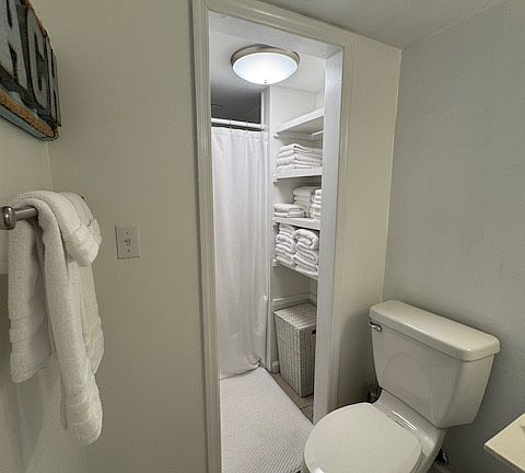 Downstairs bath with linen closet and shower. Across from kitchen.