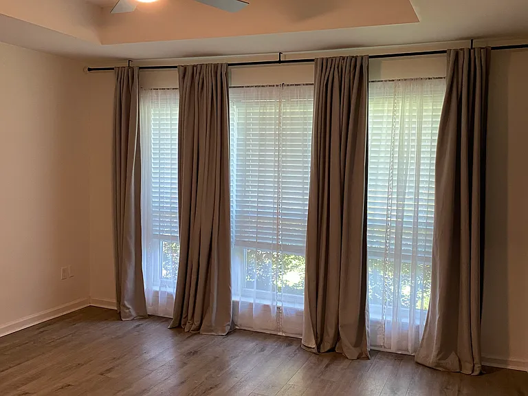 Primary bedroom _ tray ceiling, remote controlled fan & light, curtains, and blinds