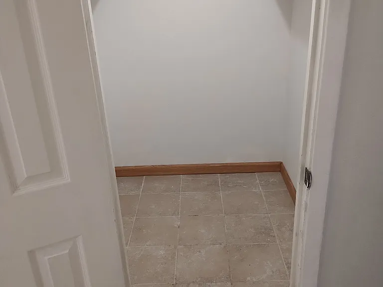 Hallway walk in closet. Roughly 25 square feet.
