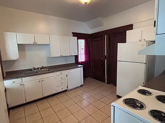 Kitchen with access to shared basement with laundry