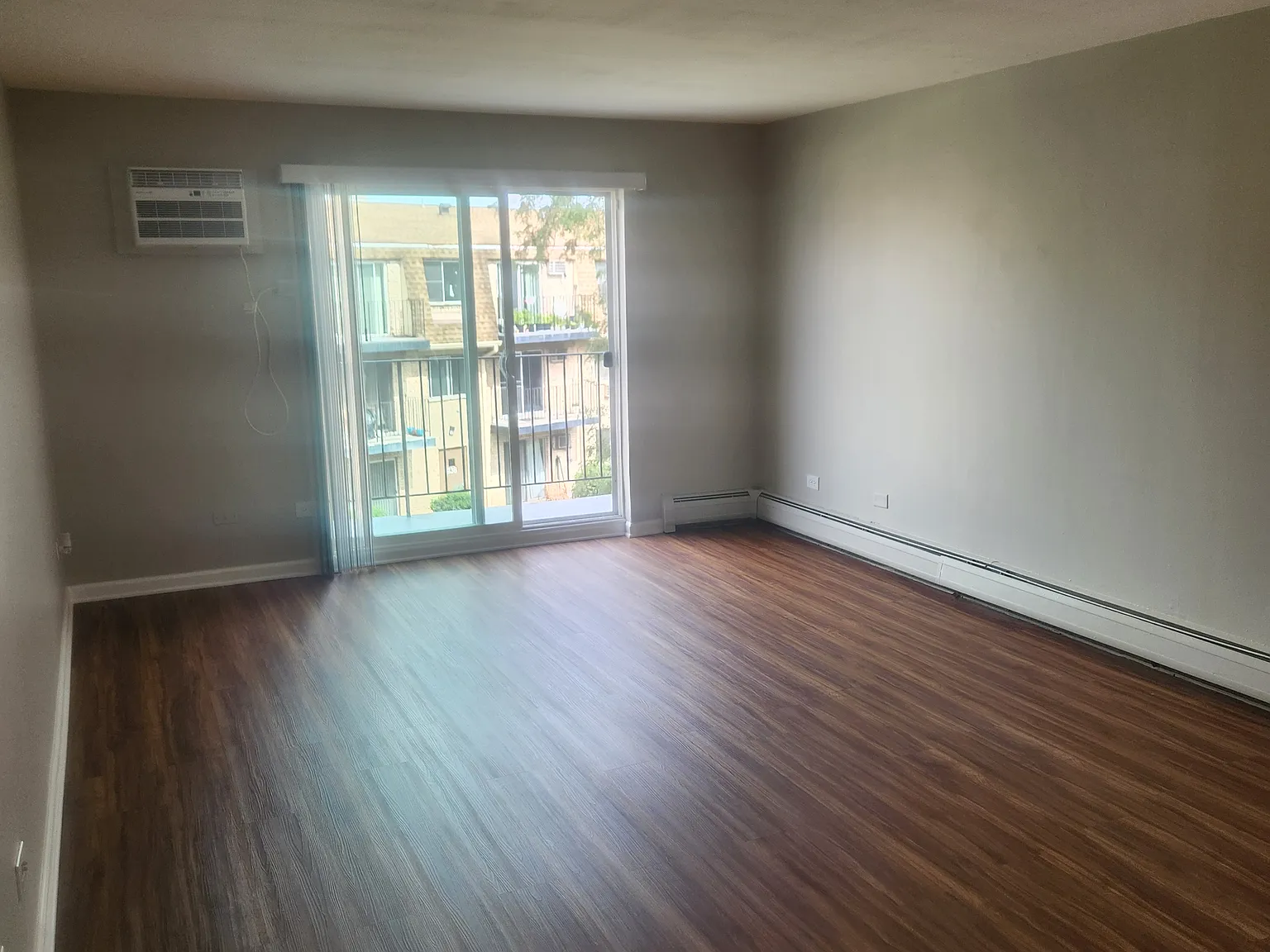 Living room with sliding glass door onto balcony.