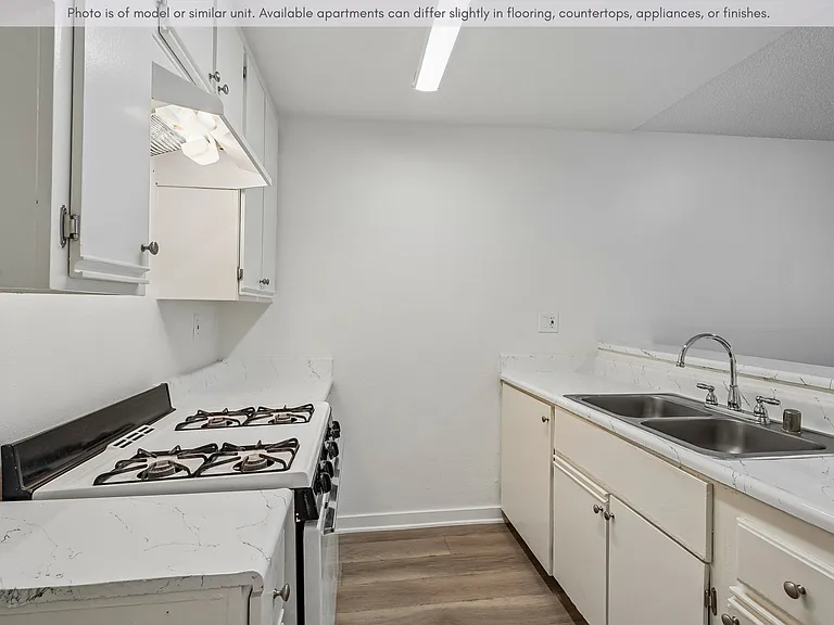 Efficient galley-style kitchen featuring generous cabinet storage and a clean, practical design.