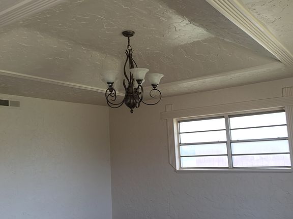 Recessed ceiling design in living room with chandelier