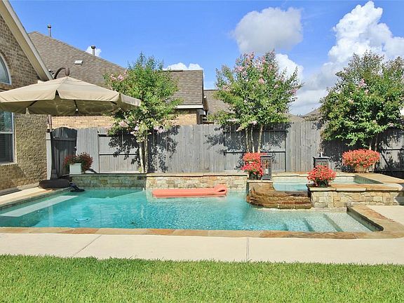 You'll love this custom designed Pool/Spa with a tranquil water feature that adds a soothing soundtrack to the back yard.