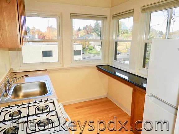 The kitchen features oak cabinets and a gas range.