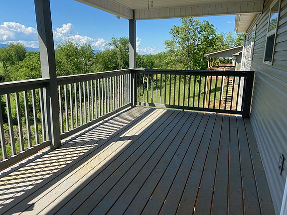 covered deck with stairs to fenced yard