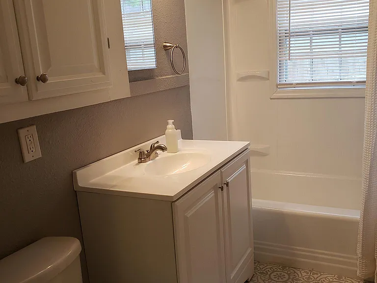 Update bathroom with LOTS of storage, including a linen/bath closet. The shower has been recently updated woth new tile surround -- the plastic insert version in this photo has been replaced.
