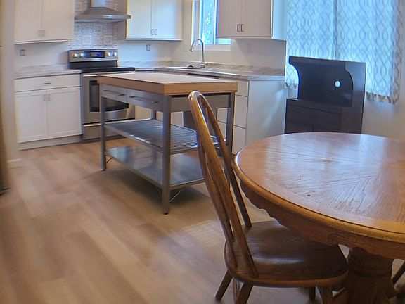 Flooring throughout kitchen, living room, and hallway