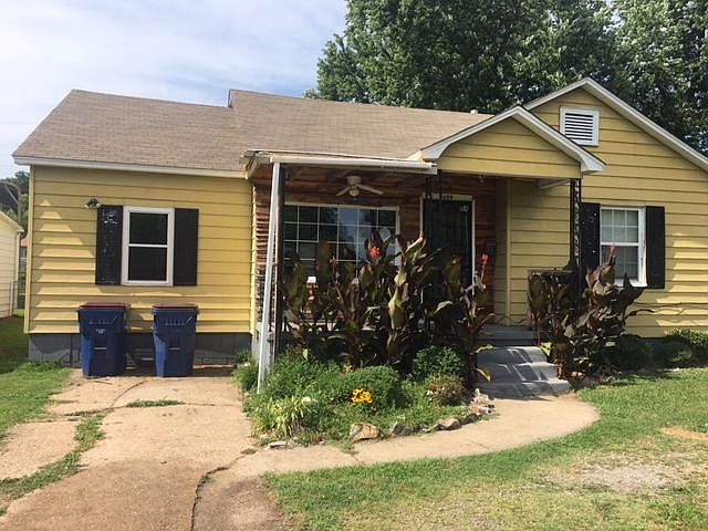 front with parking in drive way, and in front of house. 