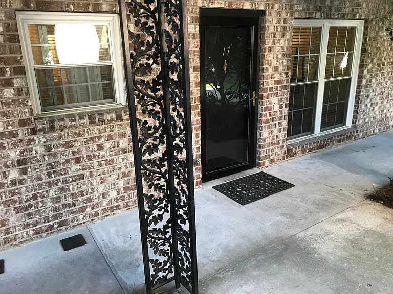 Standing in the courtyard, kitchen window, door and living room window