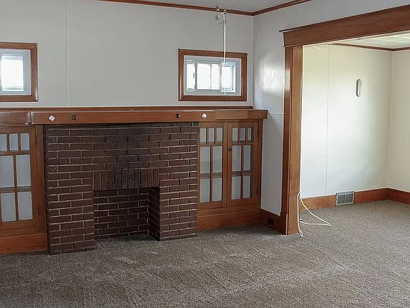 living room with fireplace (non working) and front den