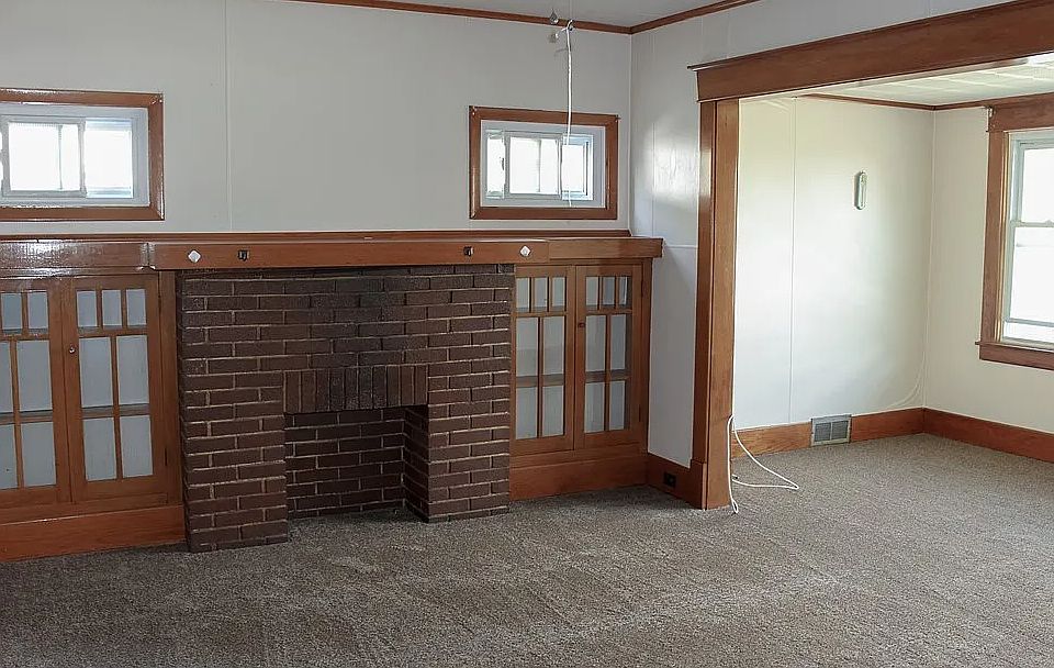 living room with fireplace (non working) and front den