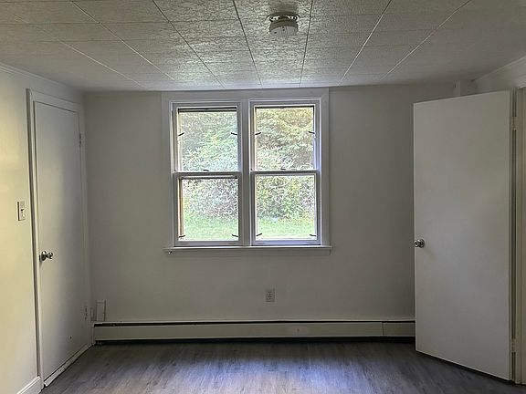 Bedroom, standing at closet doors looking toward backyard