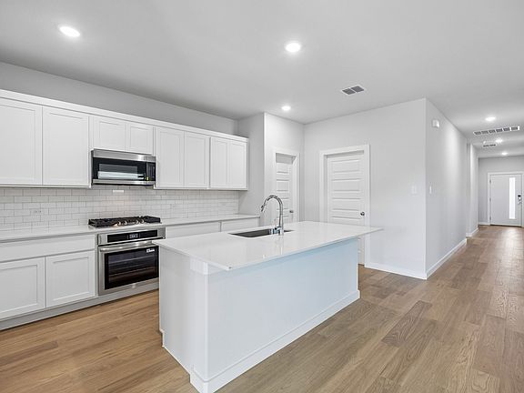 Kitchen in the Oscar home plan by Trophy Signature Homes - REPRESENTATIVE PHOTO