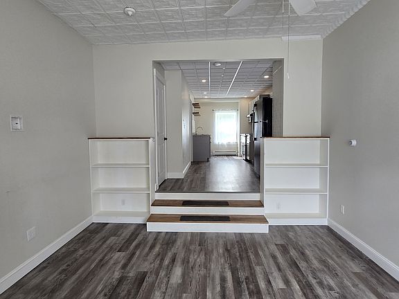New paint, new flooring, custom made bookshelves, Tin ceiling in living room.