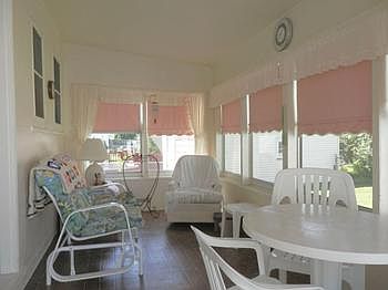 A great screened in porch overlooks a fenced back yard.