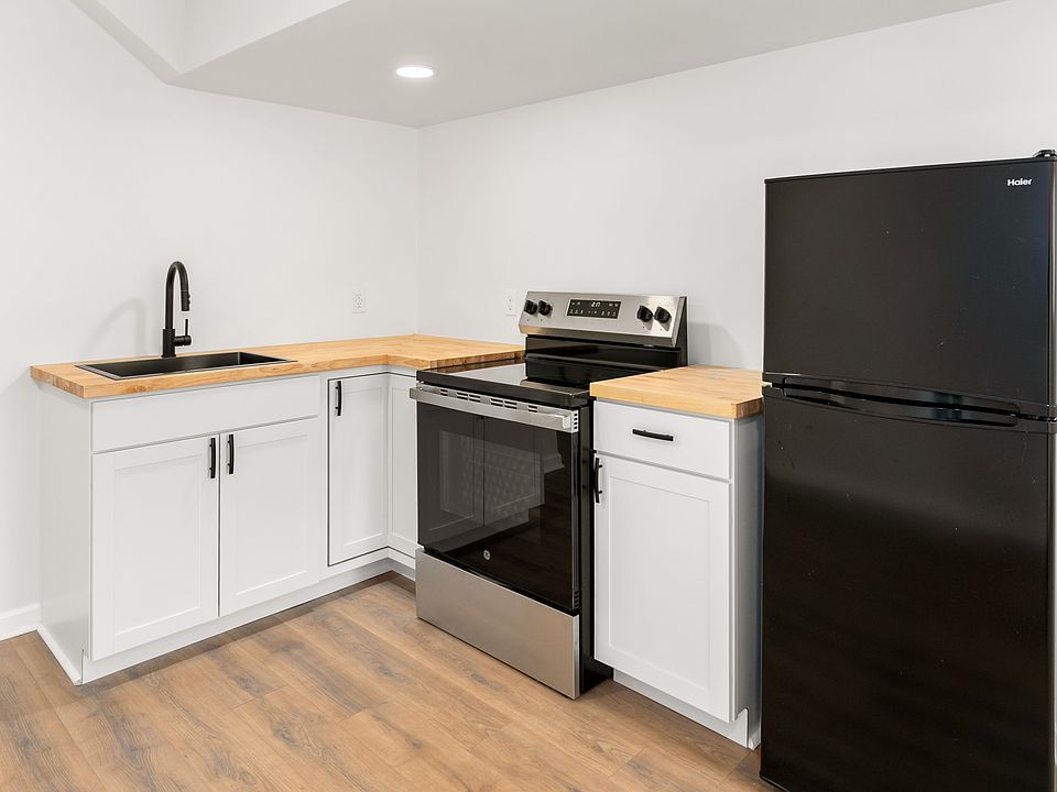 Full kitchen with apartment sized fridge, electric range and oven.