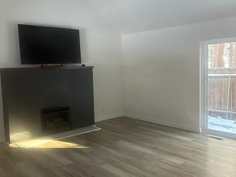 Living room looking from kitchen. Fireplace with gas insert