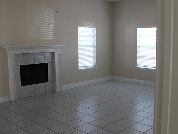Oversized den area features wood burning fireplace, abundant