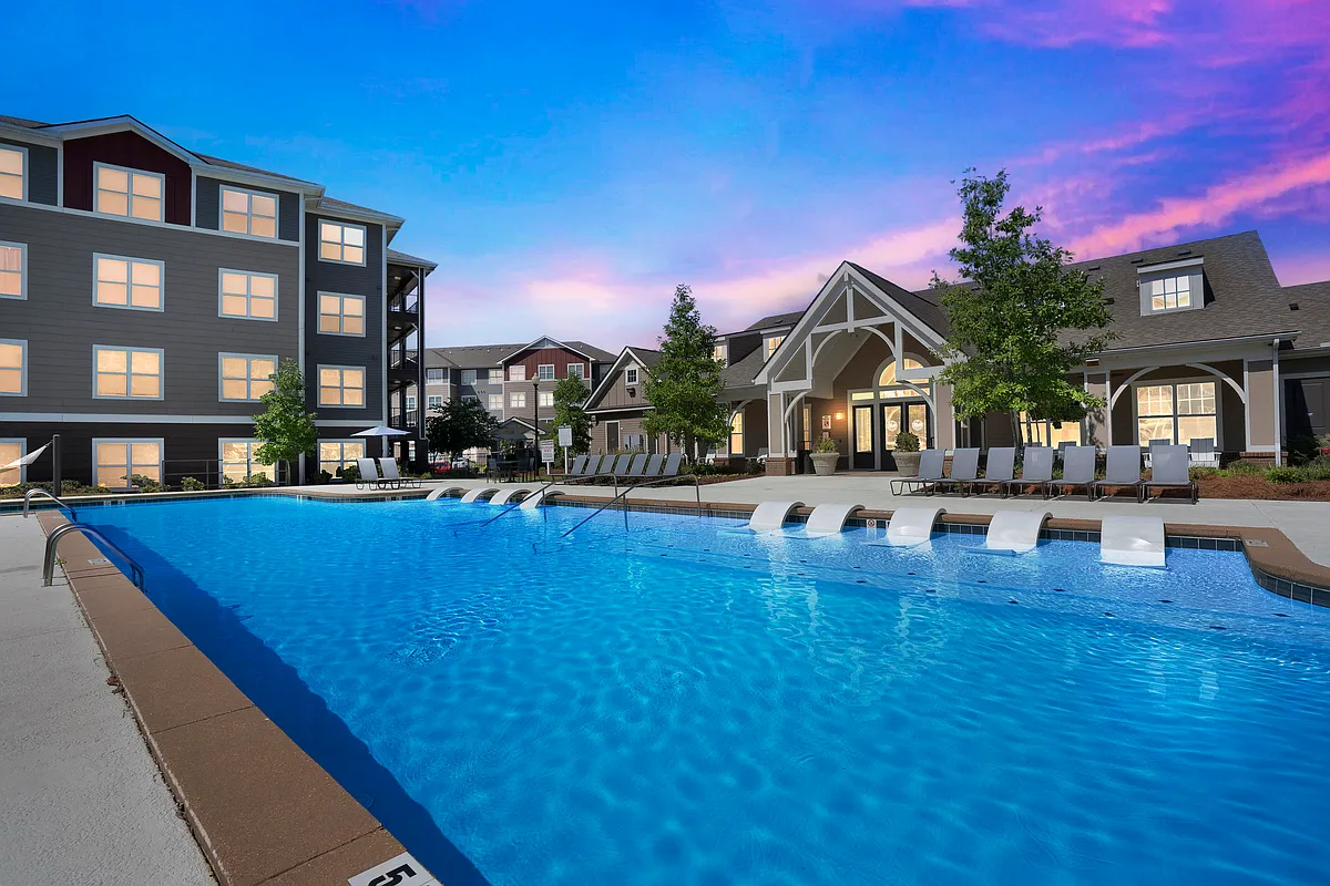 Relax by the resort-style pool and enjoy the luxurious clubhouse amenities at The Flatts Starkville. - The Flatts Starkville