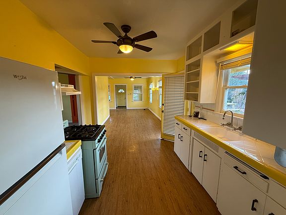 View looking from kitchen into the living room, into the sunporch entry