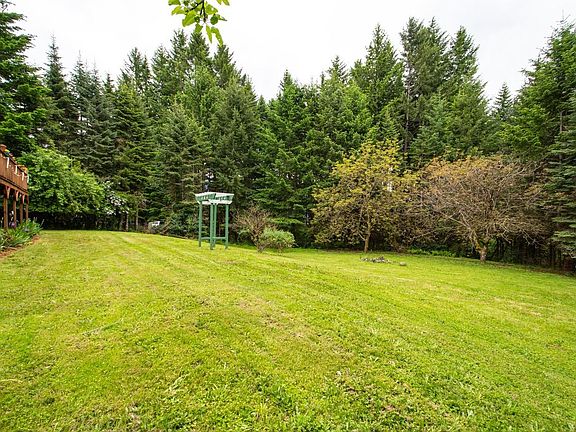 0.75 acre property surrounded by evergreen trees.