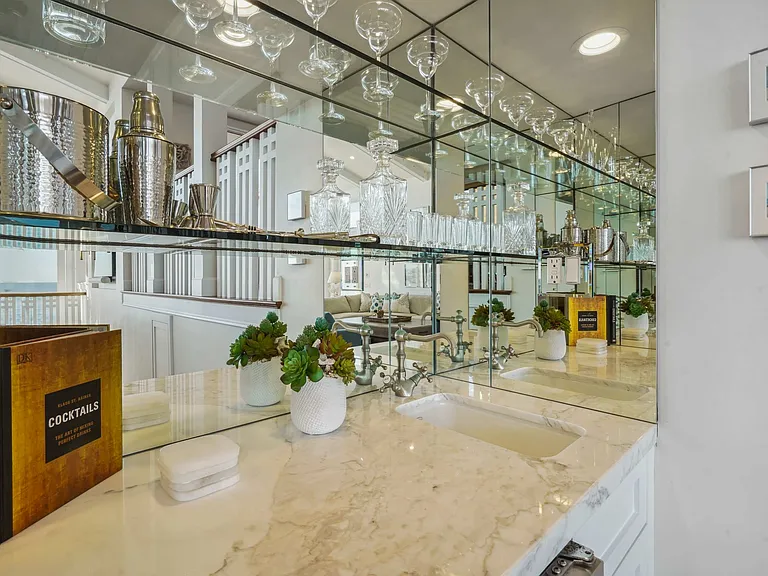 Sip in style with a mirrored bar that reflects the elegance of Malibu.