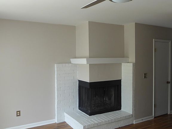 fireplace and ceiling fan in living room