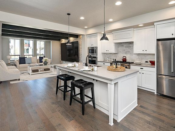 Kitchen & Great Room with Open Beams and Warm Wood Floors