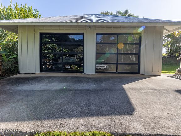 350sf Studio located on right. An entry door along with outdoor shower is located around the corner on the south wall. 350Sf Garage, storage & W/D located on left.