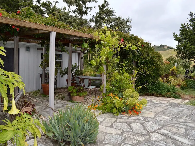 Cottage entrance with arbor off kitchen