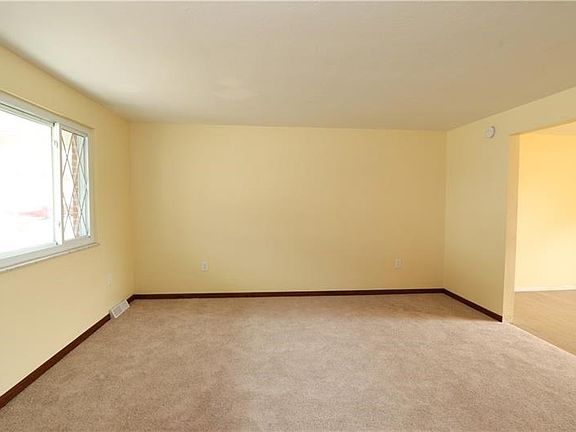 Living room with picture window. New carpeting was installed throughout the main floor in February 2019.