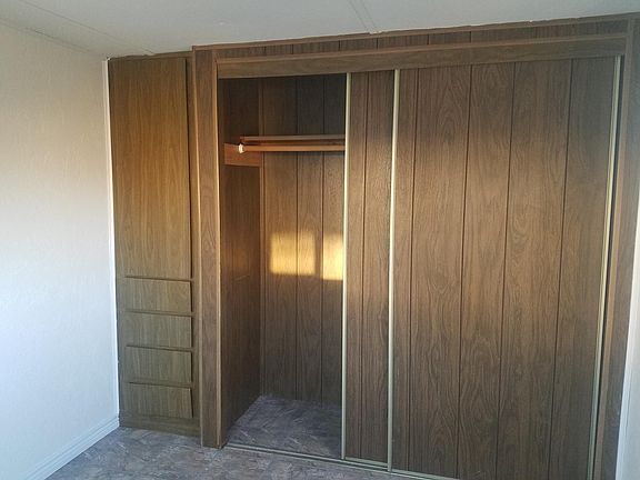 Closet and built in dresser drawers rear bedroom