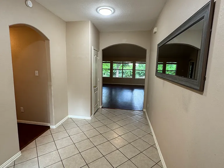 Foyer, left to hallway and secondary bedrooms, straight to living room, kitchen, master
