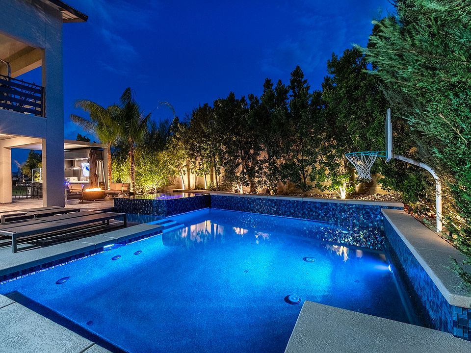 Outdoor Pool: extra large hot tub with infinity edge, large pool with basketball, in ground cleaning system, led lights . all controlled by remote
