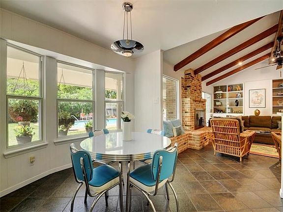 Sunlit eating nook looks out to beautiful backyard