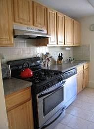 Kitchen with stainless steel appliance, granite Countertops and backsplash.