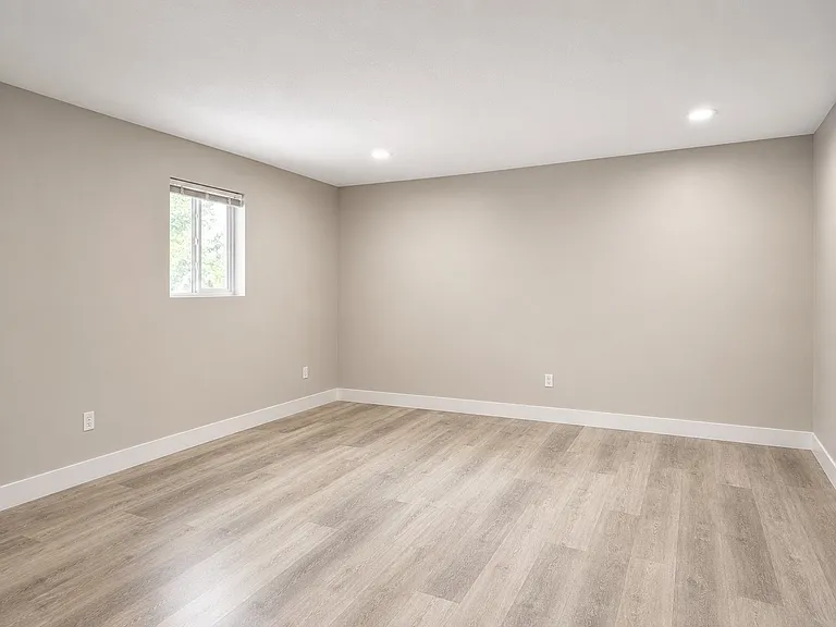 Bright and versatile second bedroom with updated flooring, neutral colors, and flexible space for a guest room, home office, or additional bedroom.