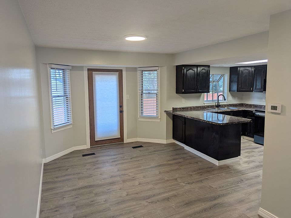 Dining room with exterior door to back patio & Kitchen
