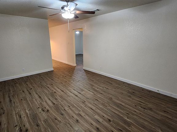 Living room leads to kitchen, two bedrooms and a bathroom.