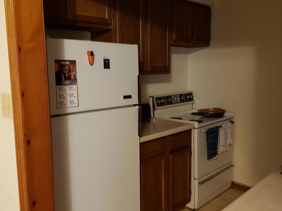 Kitchen showing more cabinets, refrigerator & stove