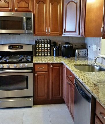 Kitchen in new cond, granite counter S steel appliances with maple cabinets