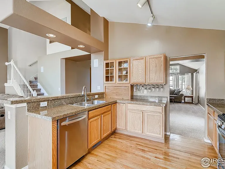 Kitchen with granite countertops, gas range, dishwasher and double door fridge